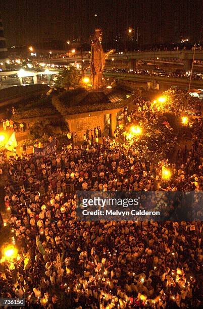 Tens of thousands of protesters gather at the historic EDSA Shrine at suburban Mandaluyong for a rally January 17, 2001 in Manila, the Philippines....