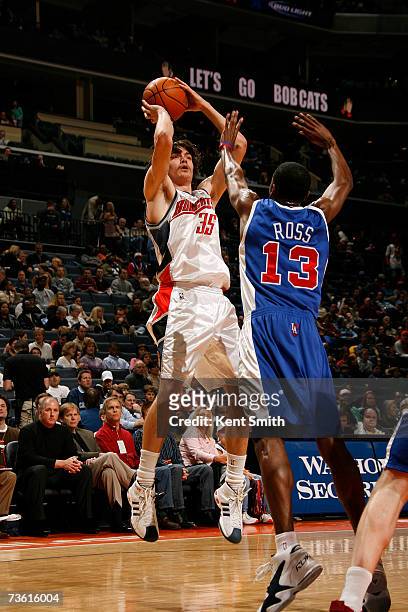 Adam Morrison of the Charlotte Bobcats shoots over Quinton Ross of the Los Angeles Clippers at the Charlotte Bobcats Arena March 16, 2007 in...