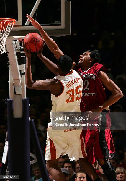 Martin Iti of the New Mexico State Aggies goes up for the block on a shot attempt by Kevin Durant of the Texas Longhorns during the first round of...