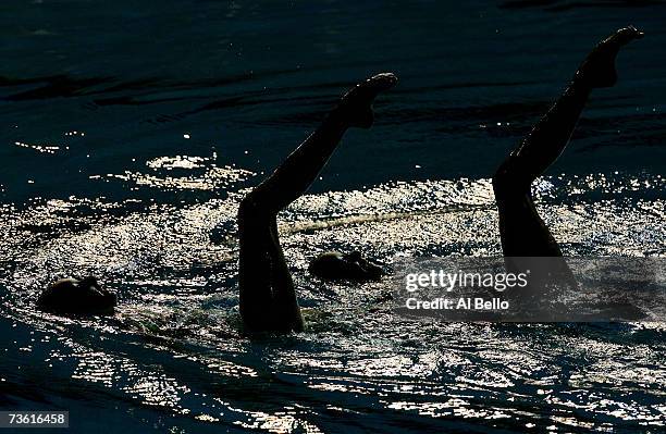 Olivia Allison and Jenna Randall of Great Britain compete in their Duet Technical Preliminary routine of the synchronized swimming event during the...