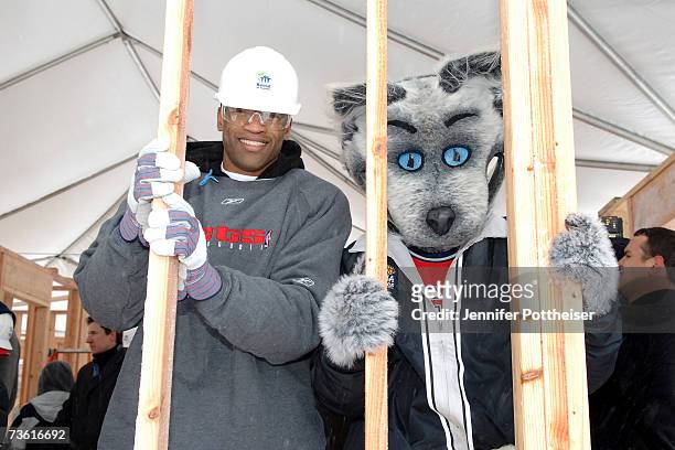 Vince Carter and Mascot Sly Fox of the New Jersey Nets help to build a house for Habitat for Humanity March 16, 2007 in East Rutherford, New Jersey....
