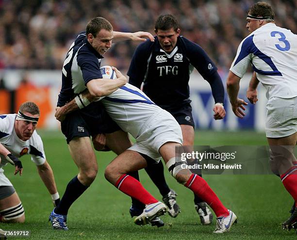 Andrew Henderson of Scotland is tackled by Raphael Ibanez of France during the RBS Six Nations Rugby match between France and Scotland at the Stade...