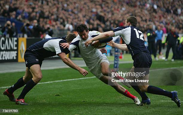 Clement Poitrenaud of France is tackled by Nikki Walker and Andrew Henderson of Scotland during the RBS Six Nations Rugby match between France and...