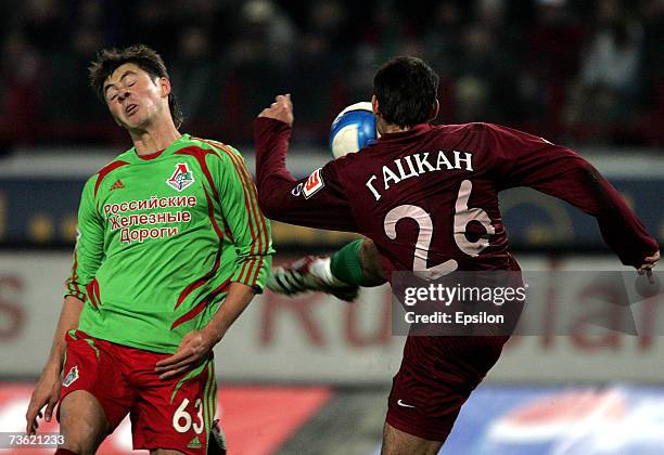 Diniyar Bilyaletdinov of FC Lokomotiv Moscow competes for the ball with Aleksandr Gatcan of FC Rubin Kazan during the Russian Football League...