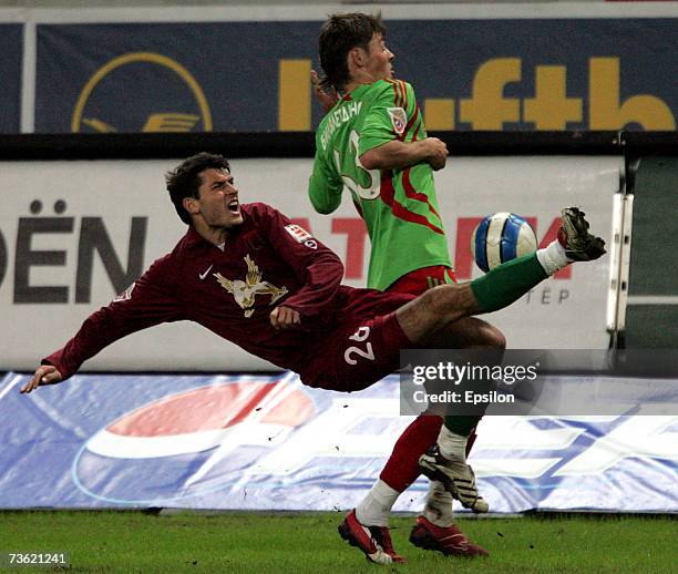 Diniyar Bilyaletdinov of FC Lokomotiv Moscow competes for the ball with Aleksandr Gatcan of FC Rubin Kazan during the Russian Football League...