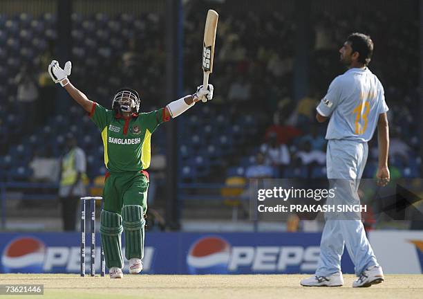 Port-of-Spain, TRINIDAD AND TOBAGO: Bangladesh Cricketer Mushfiqur Rahim celebrates the victory over India as India Cricketer Munaf Patel looks on,...