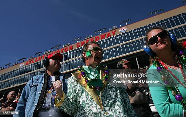 Robert Knotts celebrates St. Patricks Day with Cheryl Greely and Bill Dobbs, as they watch the NASCAR Busch Series Nicorette 300 at Atlanta Motor...