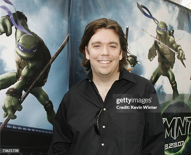 Director Kevin Munroe poses with a Teenage Mutant Ninja Turtle at the premiere of Warner Bros. Picture's Teenage Mutant Ninja Turtles at the Chinese...