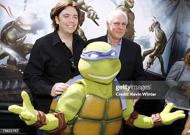 Director Kevin Munroe and producer Thomas K. Gray pose with a Teenage Mutant Ninja Turtle at the premiere of Warner Bros. Picture's Teenage Mutant...