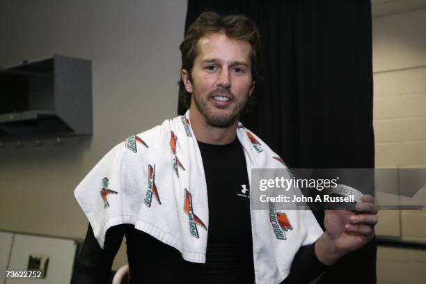 Mike Modano of the Dallas Stars holds the puck that he scored goal with against the Nashville Predators at Nashville Arena March 17, 2007 in...