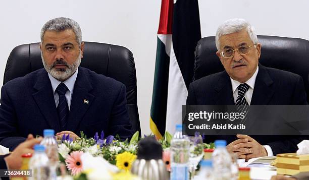 Prime Minister Ismail Haniya and Palestinian President Mahmoud Abbas chair the first meeting of the new Palestinian unity government, bringing...