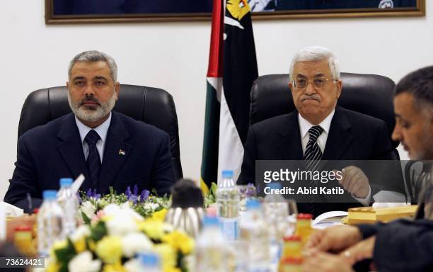 Prime Minister Ismail Haniya and Palestinian President Mahmoud Abbas chair the first meeting of the new Palestinian unity government, bringing...
