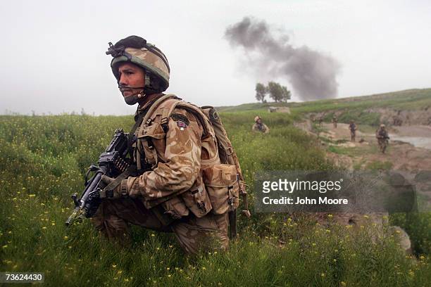 British Marine Justin Montague from Swindon, England watches for Taliban movements after an airstrike was called in on a Taliban position on March...
