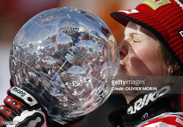 Lenzerheide, SWITZERLAND: Austria's Nicole Hosp, winner of the World Cup overall title, kisses her globe after the women's giant slalom second run at...