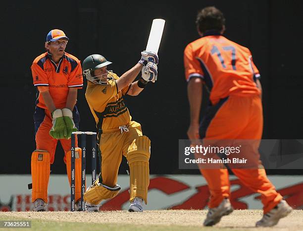 Brad Hodge of Australia hits out off the bowling of Peter Borren of Netherlands with Jeroen Smits of Netherlands looking on during the ICC Cricket...