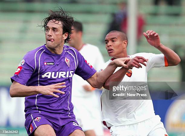 Matteo Ferrari of Roma in action with Luca Toni of Fiorentina during the match between Fiorentina and Roma at the Artemio Franchi Stadium on March...