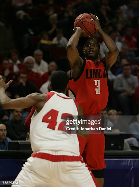 Michael Umeh of the UNLV Runnin' Rebels attempts a shot against Alando Tucker of the Wisconsin Badgers during the second round of the NCAA Men's...