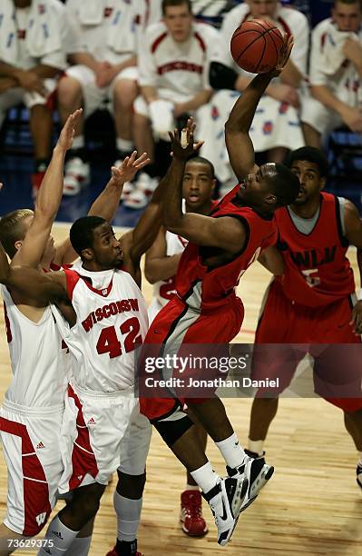 Michael Umeh of the UNLV Runnin' Rebels attempts a shot against Alando Tucker of the Wisconsin Badgers during the second round of the NCAA Men's...