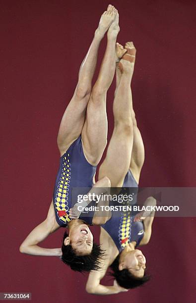 China's Jia Tong and Chen Ruolin perform a backward 2 1/2 sommersault with 1 1/2 twists during the women's 10m synchro platform diving final at the...