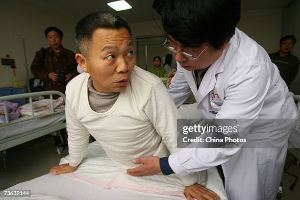 Doctor performs a physical examination of Peng Shuilin, whose body was severed in half in a traffic accident, March 18, 2007 in Beijing, China....