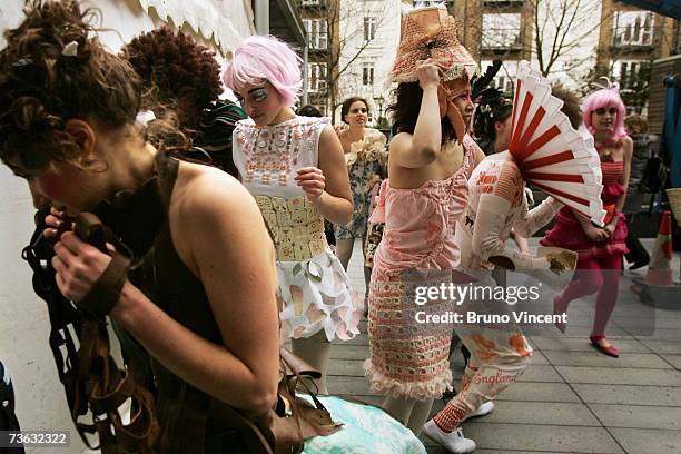 Models wearing creations by Chelsea College of Art and Design seek shelter as a cold wind blows at Swatch Alternative Fashion Week on March 19, 2007...