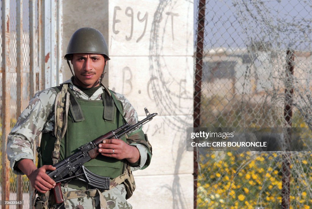 An Egyptian army soldier stands to guard...