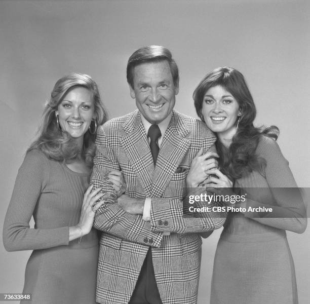 American game show host Bob Barker poses flanked by two of the so-called 'Barker's Beauties' models, Janice Pennington and Anitra Ford, for the CBS...