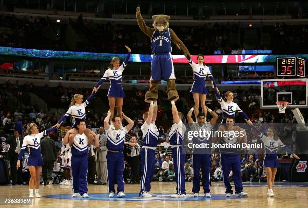 The mascot and cheerleaders from the Kentucky Wildcats perform a stunt during a timeout against the Kansas Jayhawks during the second round of the...