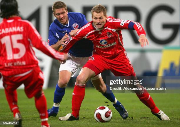 Lukas Sinkiewicz of Cologno challenges for the ball with Christian Rahn of Rostock during the Second Bundesliga match between Hansa Rostock and 1. FC...