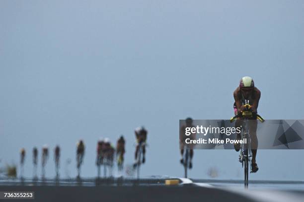 Cyclists riding through the heat haze compete in the Gatorade IronmanTriathlon on 10 October 1992 on Kona, Hawaii, United States. Visions of Sport.