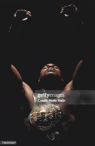 World Heavyweight Boxing Champion Oliver McCall of the United States poses for a portrait with his fists raised and the WBC Championship belt on 29...