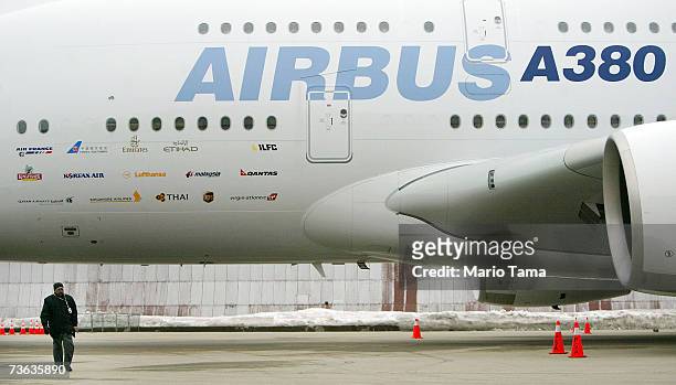 Worker walks in front of the new double-decker Lufthansa Airbus A380 after it arrived at JFK International Airport following its first route-proving...