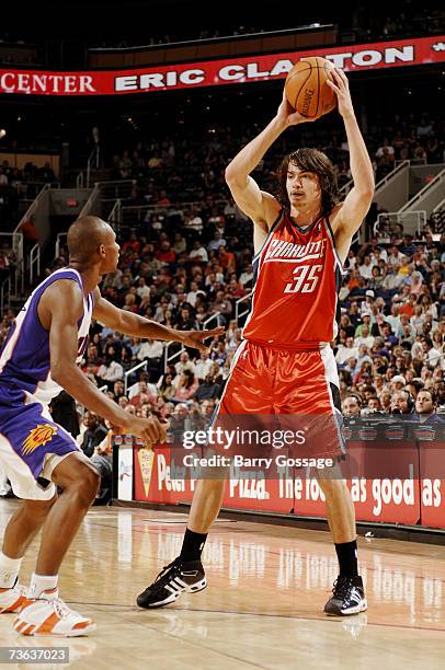 Adam Morrison of the Charlotte Bobcats looks to pass against Leandro Barbosa of the Phoenix Suns during the game on March 7 at U.S. Airways Center in...