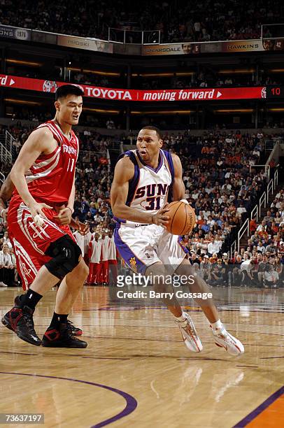 Shawn Marion of the Phoenix Suns moves the ball against Yao Ming of the Houston Rockets during the game on March 12 at U.S. Airways Center in...