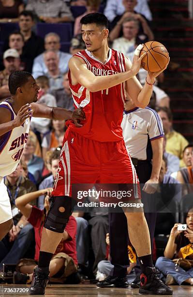 Yao Ming of the Houston Rockets looks to move the ball against Kurt Thomas of the Phoenix Suns during the game on March 12 at U.S. Airways Center in...