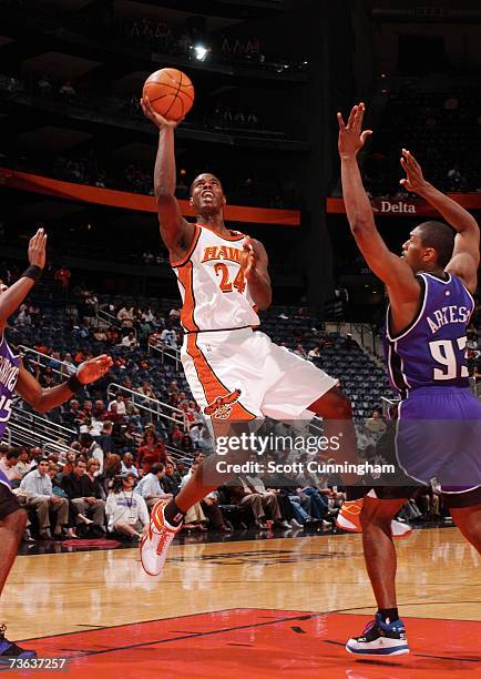 Marvin Williams of the Atlanta Hawks takes a shot against Ron Artest of the Sacramento Kings at Philips Arena on March 19, 2007 in Atlanta, Georgia....