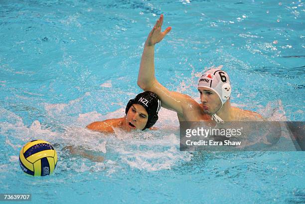Jacques Venter of New Zealand and Marton Szivos of Hungary compete for the ball during the Men's Preliminary Round Group D Water Polo match between...