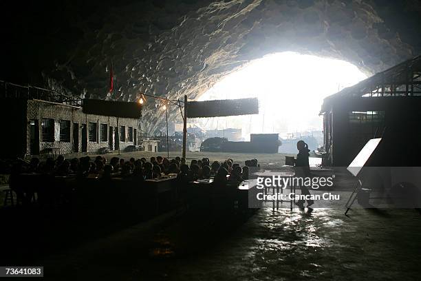 Children attend a class at their school in a huge cave at a remote Miao village March 14, 2007 in Ziyun county, Guizhou province of southwest China....