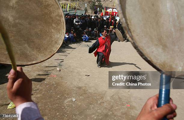 Villagers pray during a ceremony to worship the Erlang God at the Dazhuang Village on March 20, 2007 in Huzhu County of Qinghai Province, China. The...