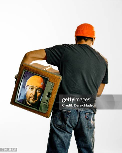 French architect, interior and product designer Philippe Starck, photographed for a cover story for French Architectural Digest magazine, holding a...