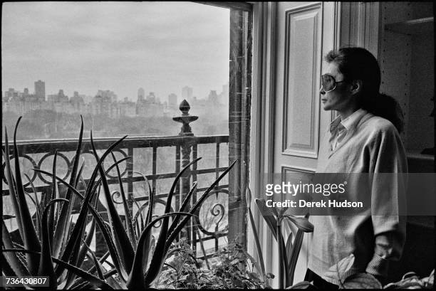 Japanese multimedia artist, singer and songwriter Yoko Ono in the lounge of the apartment she shared with John Lennon, one year to the day after he...
