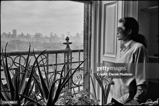 Japanese multimedia artist, singer and songwriter Yoko Ono in the lounge of the apartment she shared with John Lennon, one year to the day after he...