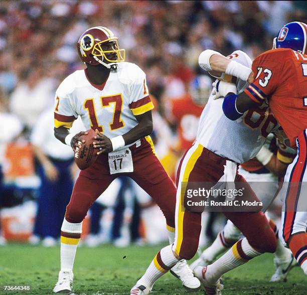 Quarterback Doug Williams of the Washington Redskins goes back to pass during Super Bowl XXII against the Denver Broncos on January 31, 1988 in San...
