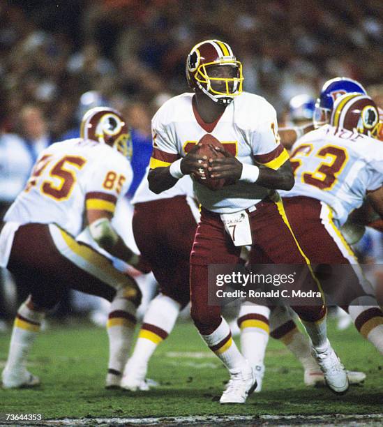 Quarterback Doug Williams of the Washington Redskins goes back to pass during Super Bowl XXII against the Denver Broncos on January 31, 1988 in San...