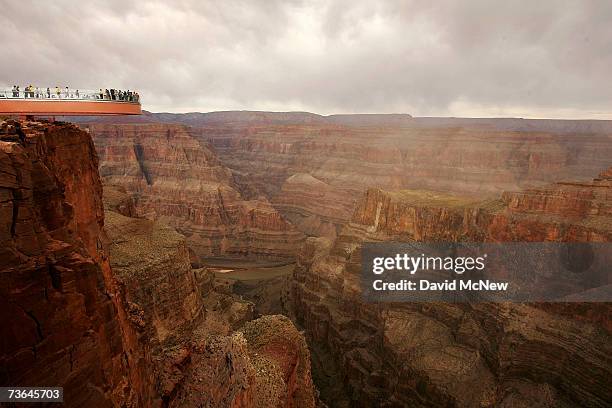 People take the first official walk on the Skywalk, billed as the first-ever cantilever-shaped glass walkway extending 70 feet from the western Grand...