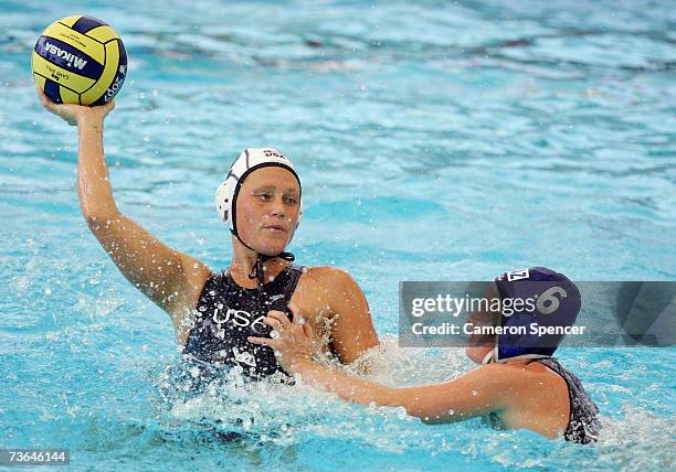 Heather Petri of the United States looks to pass around Anna Zubkova of Kazakhstan in the Women's Preliminary Round Group C Water Polo match between...