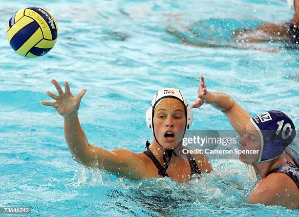 Natalie Golda of the United States passes the ball as Marina Gritsenko of Kazakhstan defends in the Women's Preliminary Round Group C Water Polo...