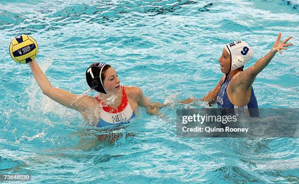 Iefke Van Belkum of Holland looks to pass the ball around Evangelia Moraitidou of Greece in the Women's Preliminary Round Group C Water Polo match...