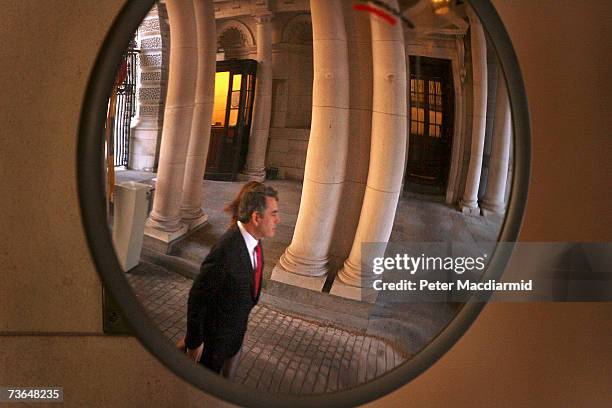 Chancellor Gordon Brown is reflected in a convex mirror as he walks into the Treasury on March 21, 2007 in London. This is likely to be Mr Brown's...