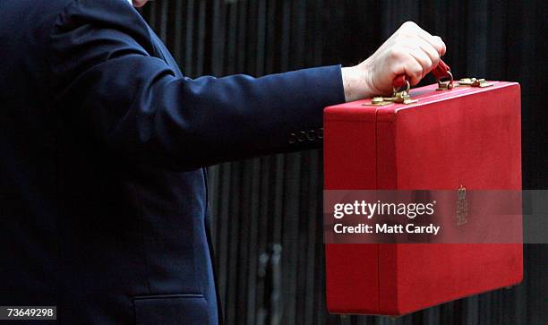 Chancellor of the Exchequer Gordon Brown holds his ministerial red box as he leaves for Parliament to present his 11th budget statemen, on March 21,...